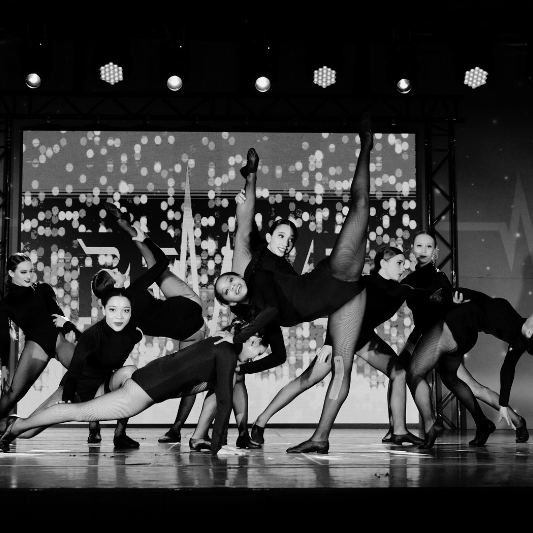 Senior dancers performing a jazz routine on stage for the Charleston Dance Center.