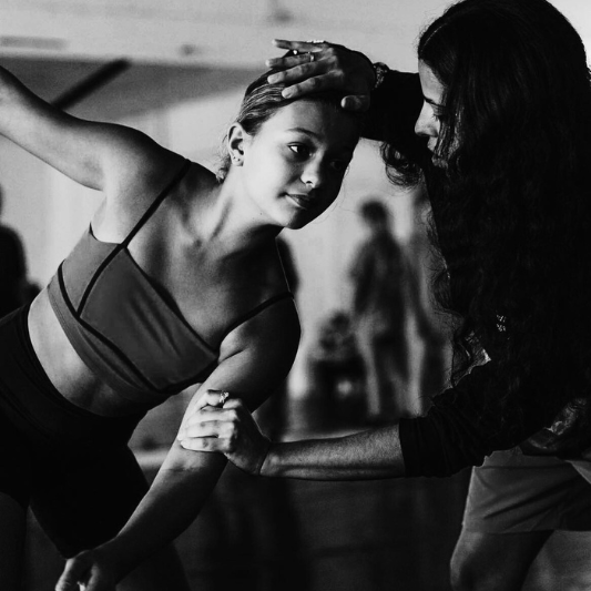 Dedicated dancer at Charleston Dance Center receiving individualized technique guidance from an attentive instructor.